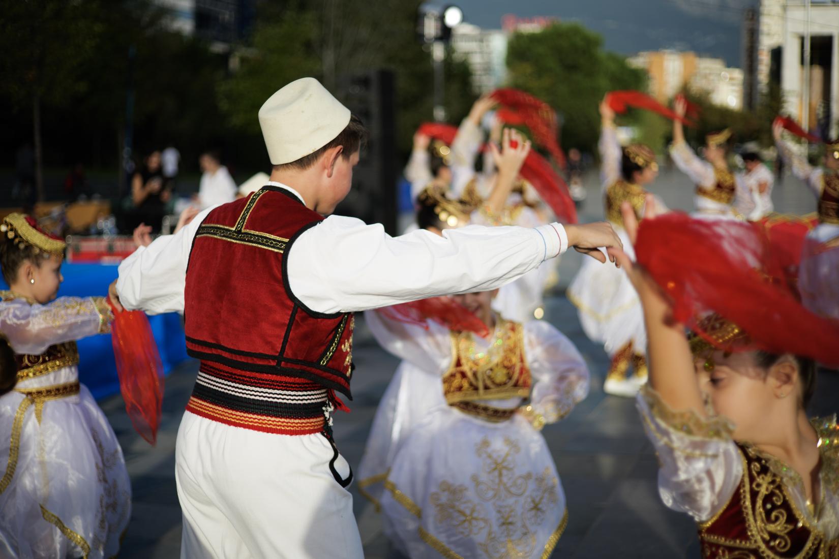 Child dressed in national costume of Albania dancing 