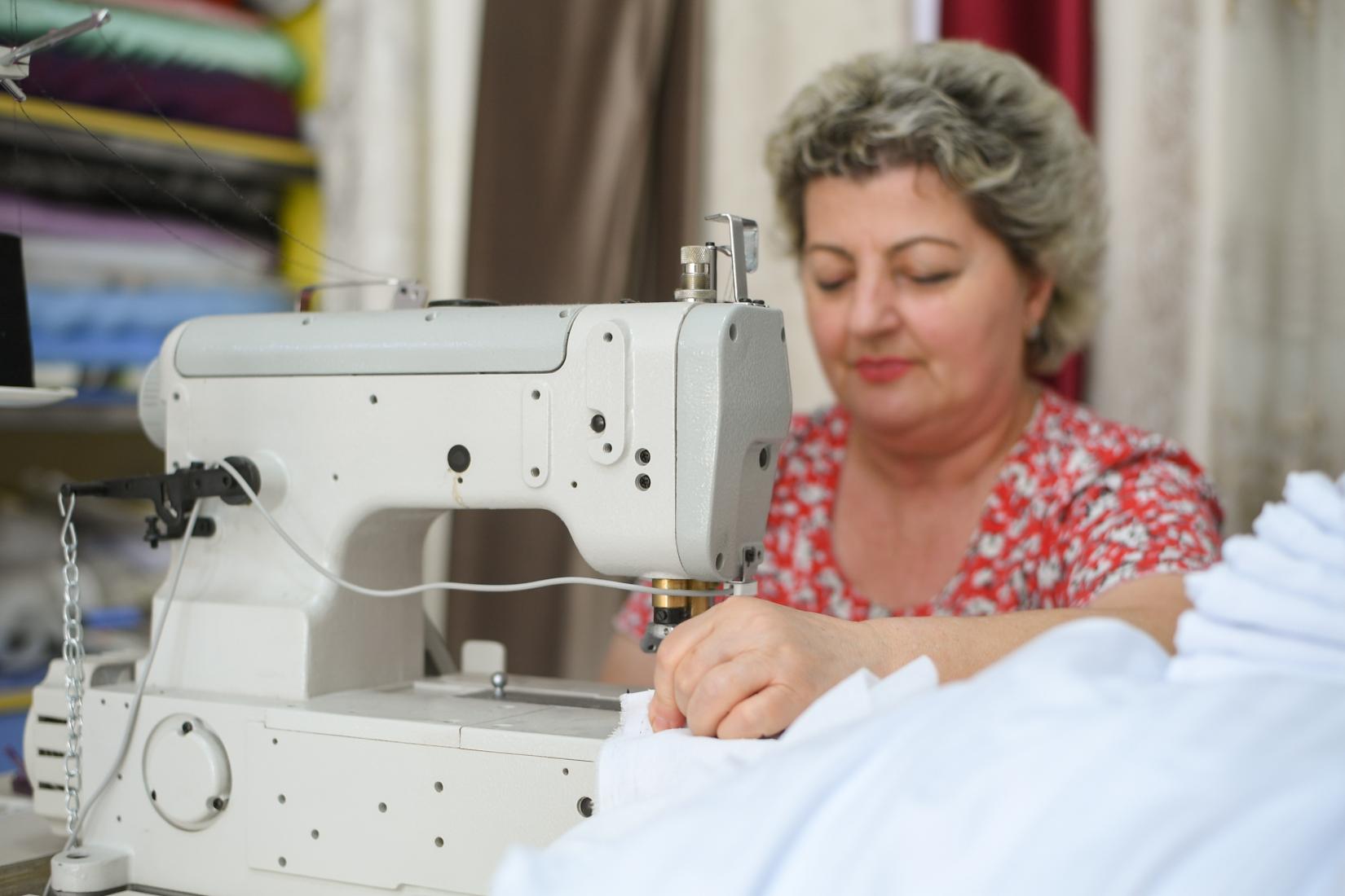 Lejla, during her work as a tailor with her new sewing machine provided by UNDP Albania under the Economic Recovery and Resilience Programme.